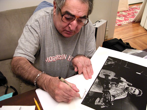 Jim Marhsall signing his famous photo.  Photo by Grover Sanschagrin